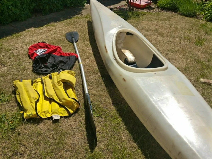 Kayak with paddle, spray deck and life jacket