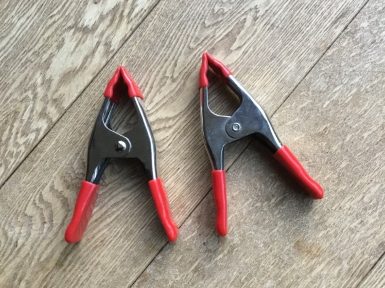 Two photo backdrop clamps
