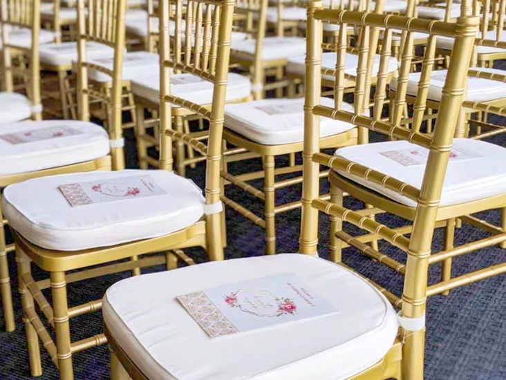 Gold chiavari chairs with ivory cushions