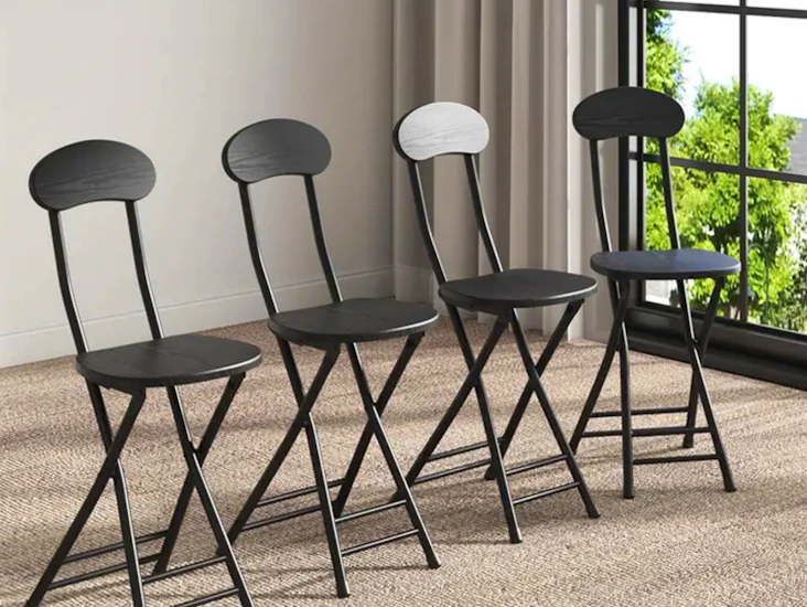 Four black folding chairs