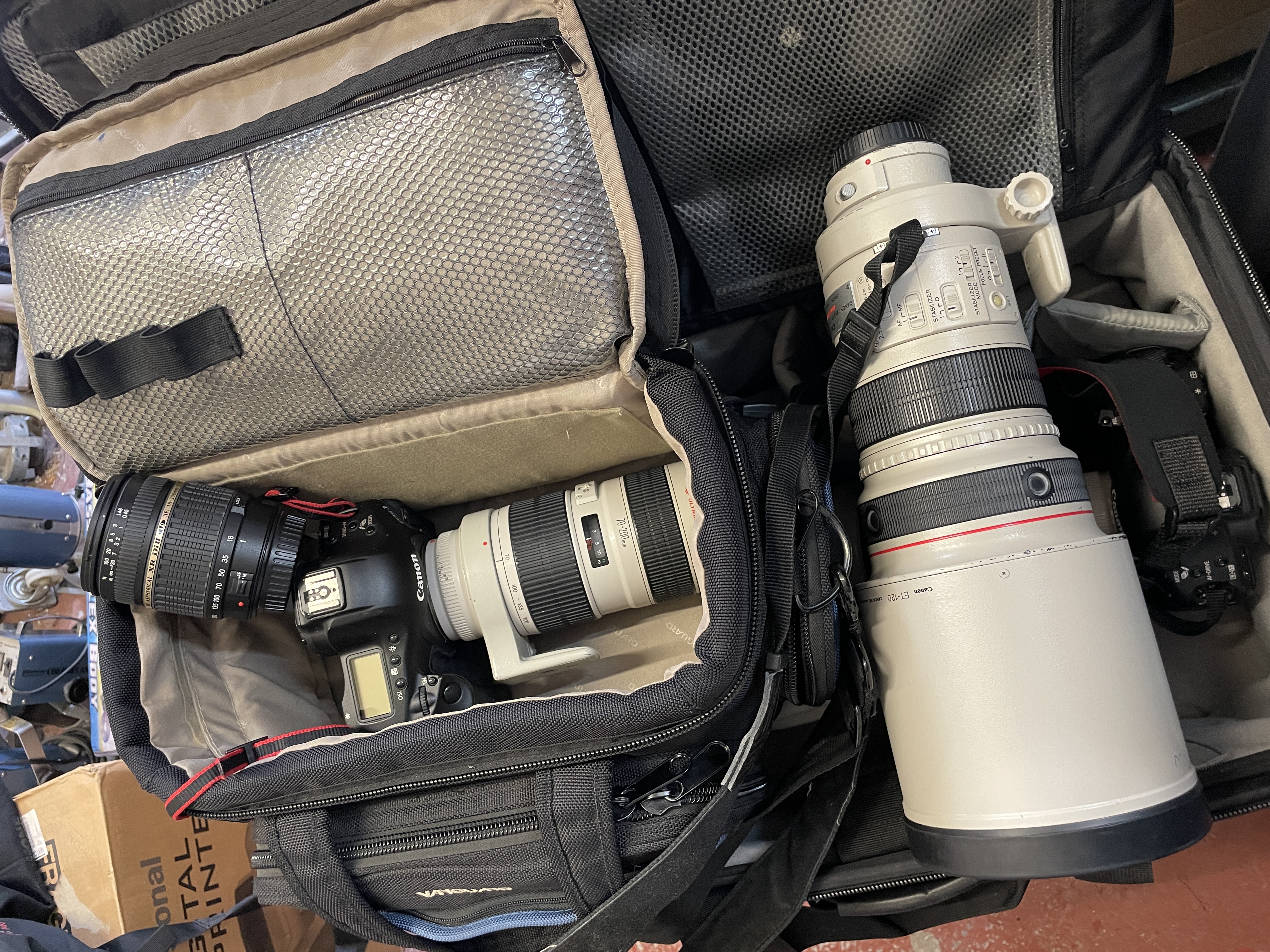 Sports and press photographers long white lens kit with flash and monopod.