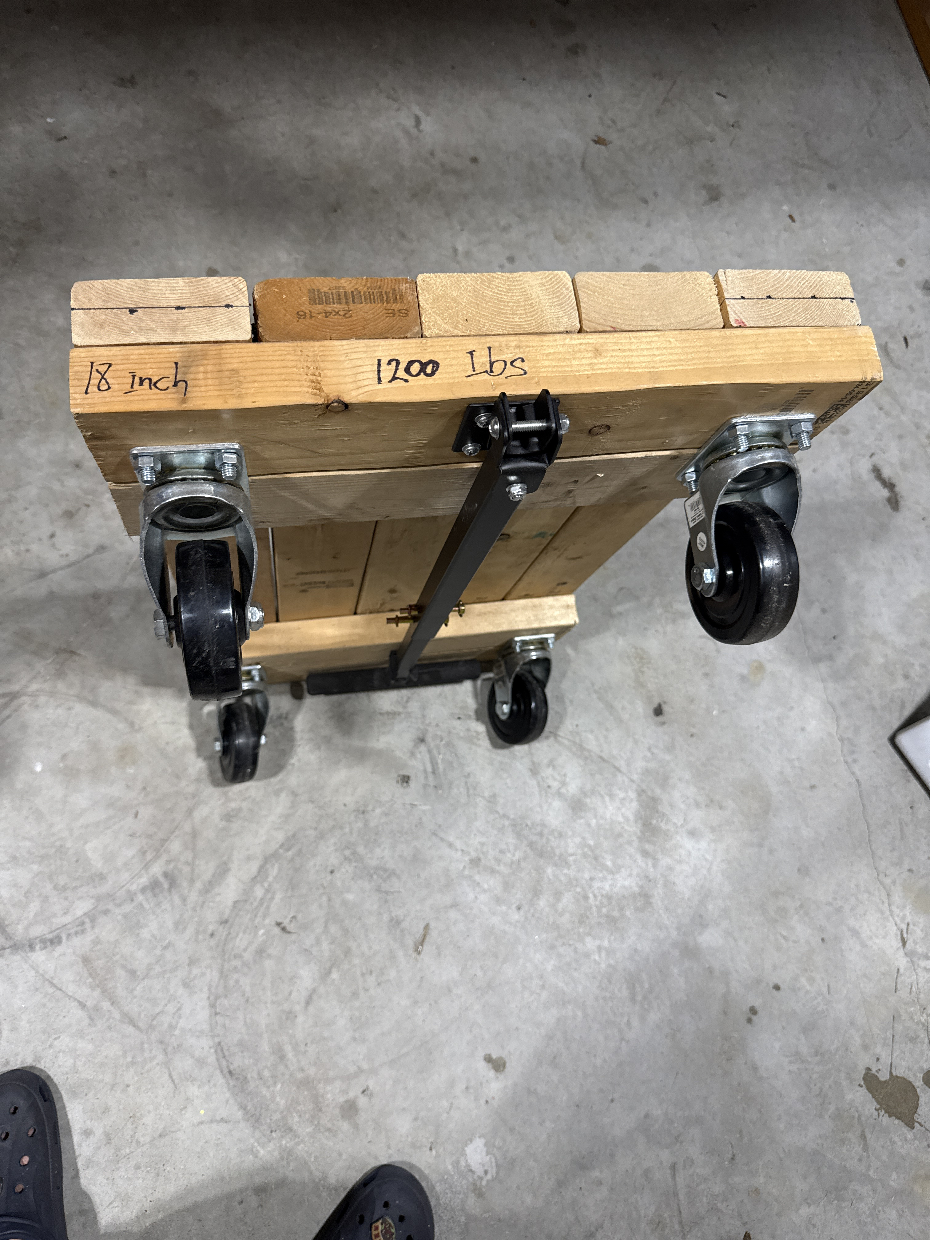 Four wheels moving dolly with handle.
