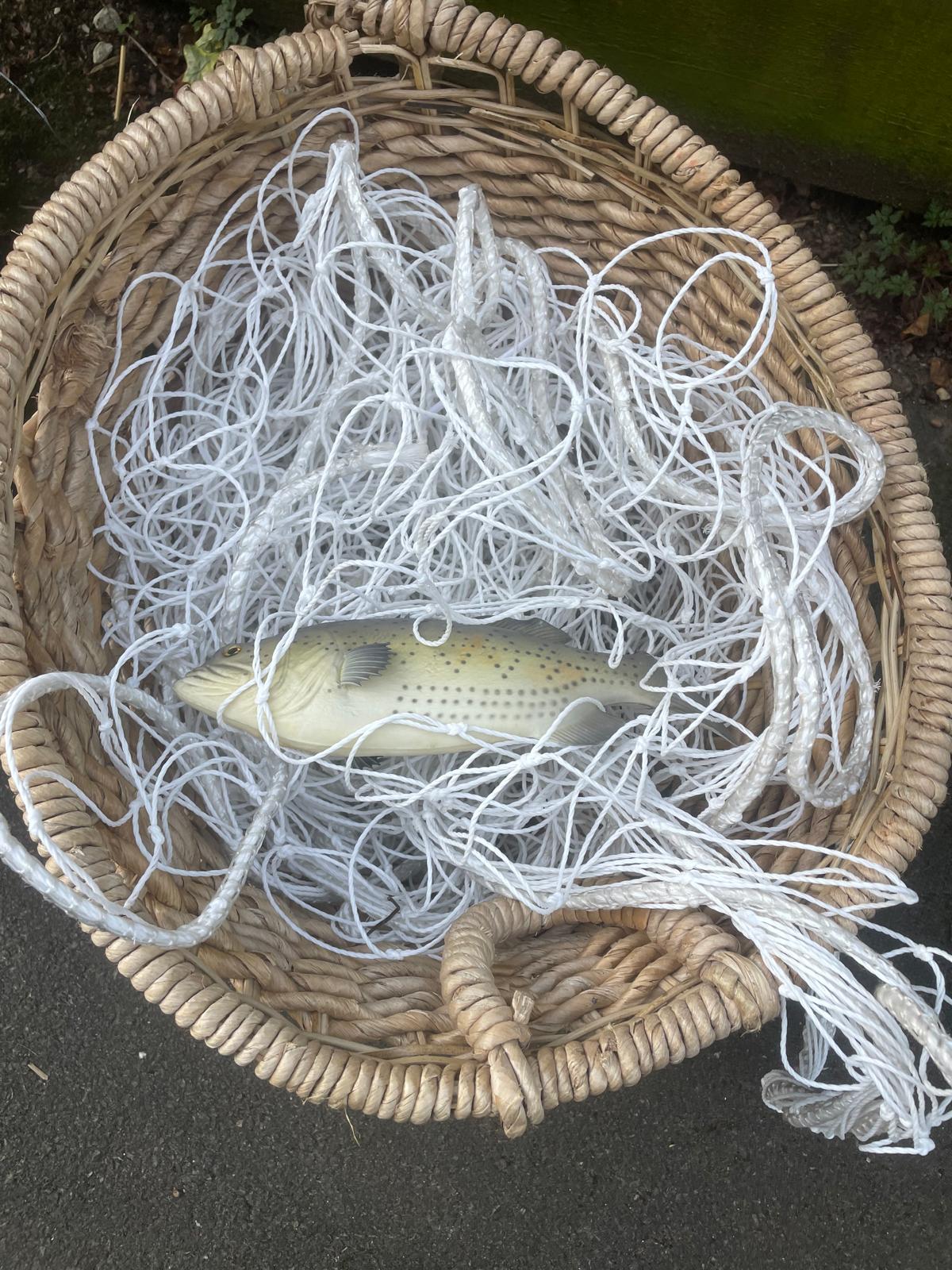 Fishing basket, net and fake fish