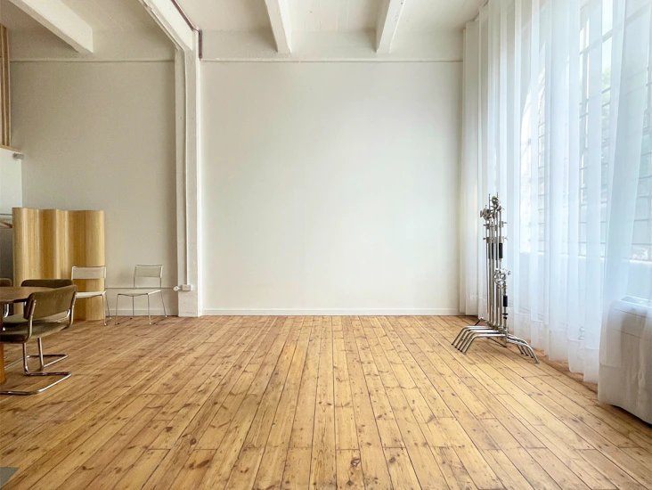 Light daylight studio with wooden floor and high ceiling