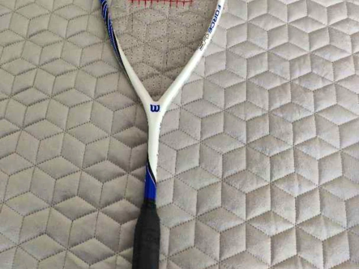 Ett squashracket med tre bollar