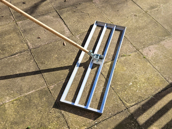 Wheelbarrow lawn levelling rake and roughneck rake