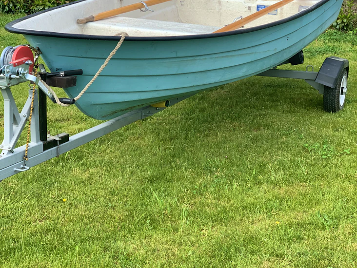 Roddbåt med åror och badstege.