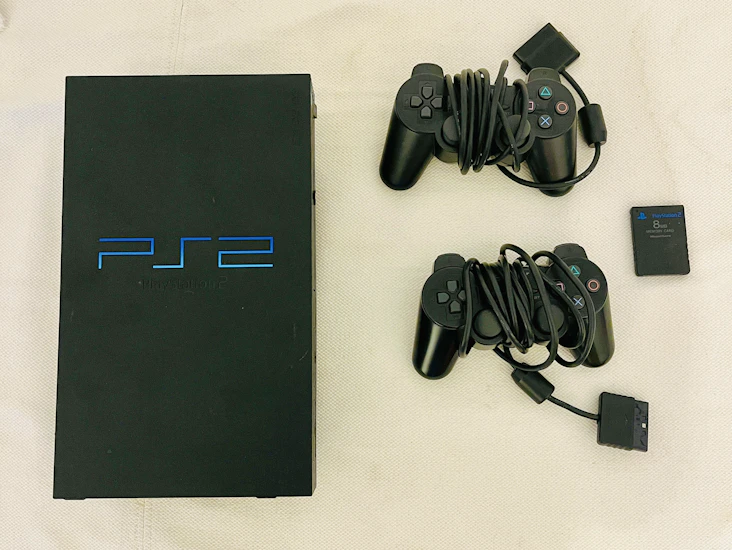 Playstation 2 console + 2 controllers + games