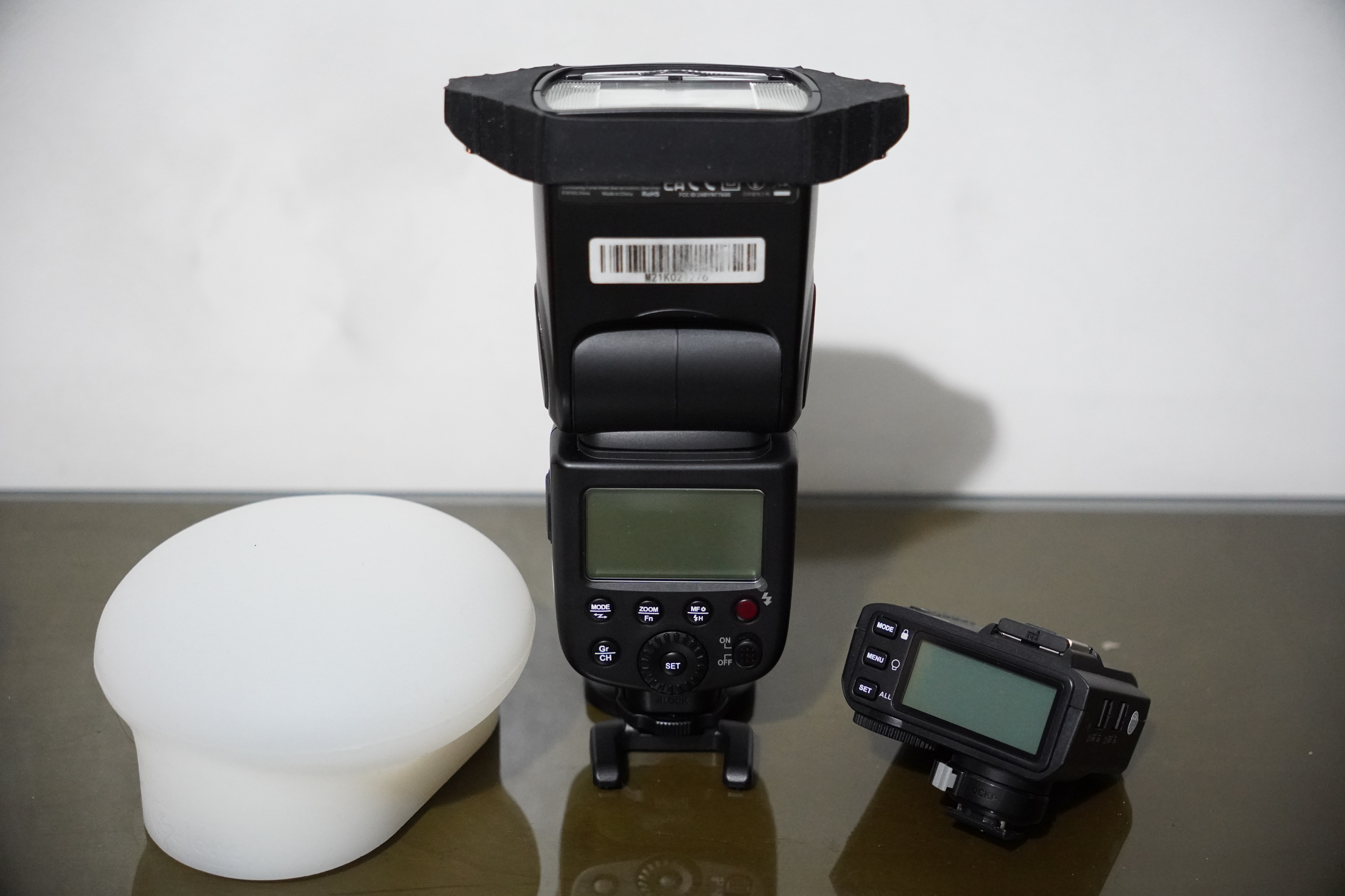 Camera flash with wireless trigger and diffuser dome