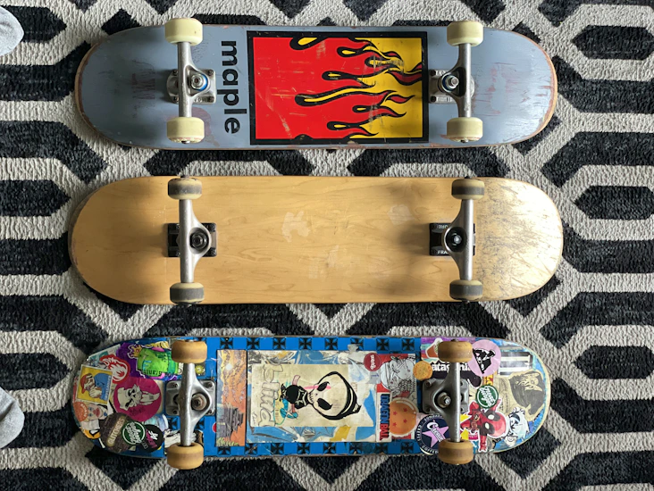 X 3 skateboards of varying designs.