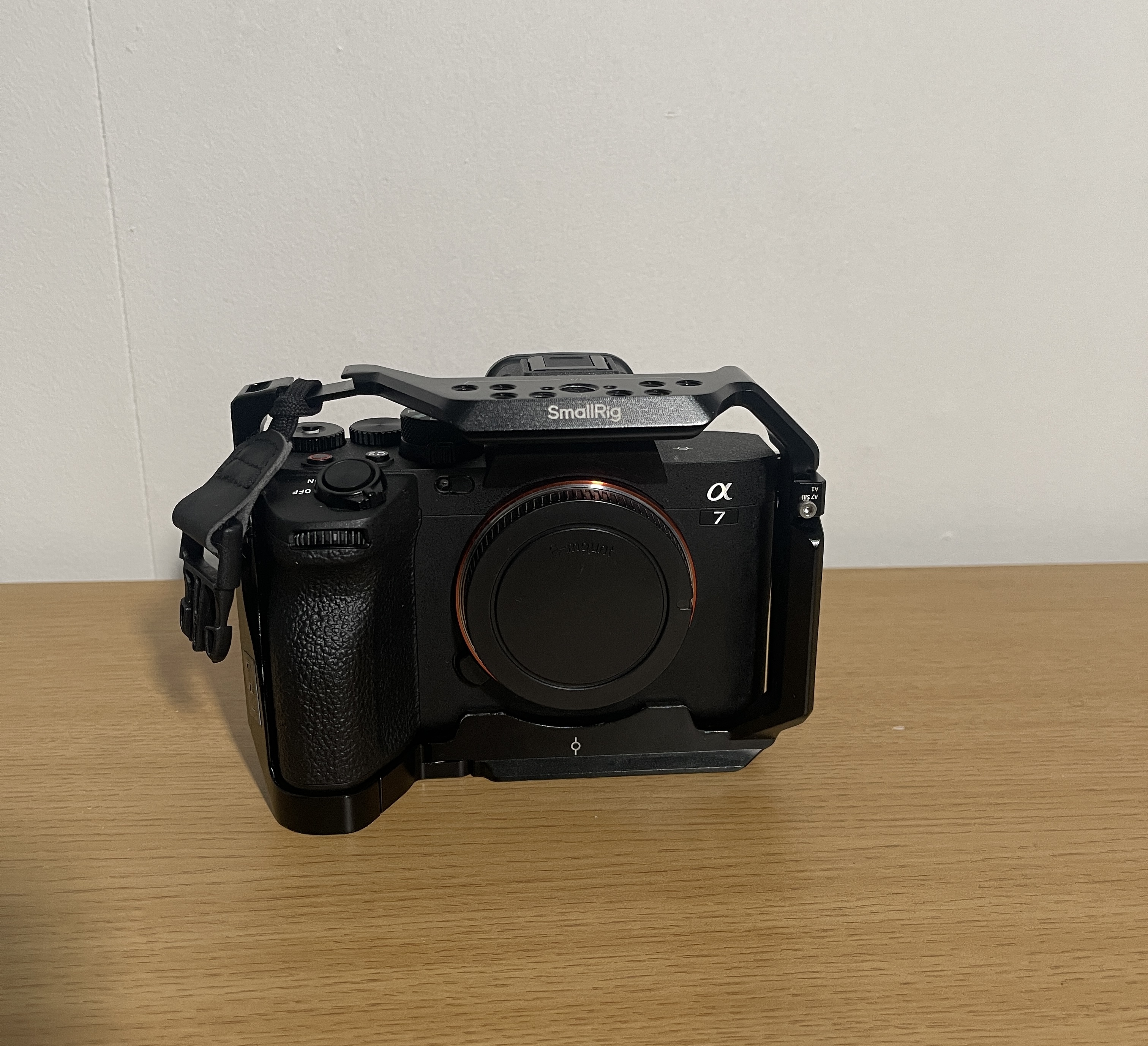 Sony a7iv (body only) + 4 batteries, includes a cage for additional attachments and portable rechargeable batteries for extended use.