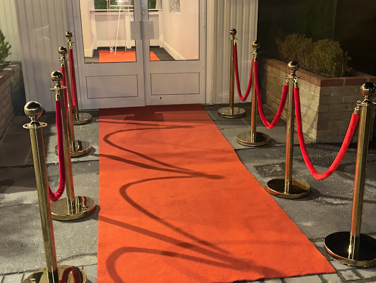 Red carpet with red rope and poles